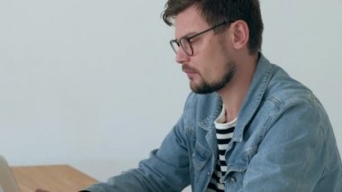 Ofis içinde belgili tanımlık laptop adam çalışıyor