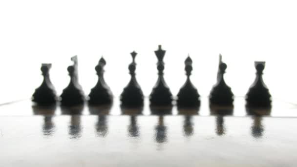 Game of chess, the silhouette figures on a white background. — Stock Video