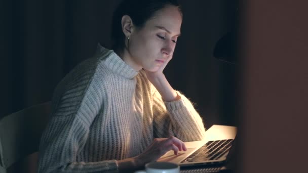 Güzel kadın uyurken dizüstü bilgisayarda çalışma uykuya düşüyor. — Stok video