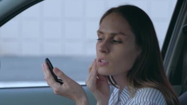 Arabada makyaj yapan kadın.