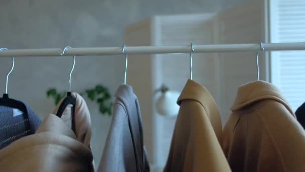 Kleidung, die im Kleiderschrank hängt. — Stockvideo