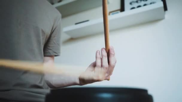 Young drummer exercising with training plastic pad at home. Lessons for percussion instruments with metronome in 60 fps can be in slow motion — Stock Video