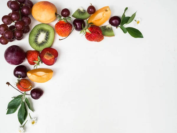 Various fruits frame on white background. Different berries and fruits on white background.