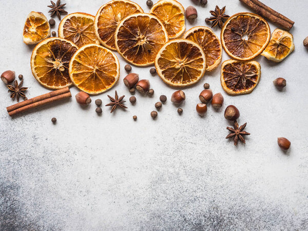 Bright Christmas or New Year background - dry orange slices and spices. Ingredients for making winter seasonal drink - mulled wine.