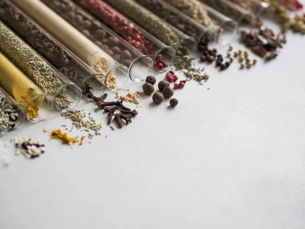 Various Dry Spices Glass Tubes Spilled Gray Background — Stock Photo, Image