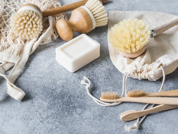 Dish washing brushes, bamboo toothbrushes, reusable bags. Sustainable lifestyle zero waste concept. Clean without waste. No plastic objects. Copy space