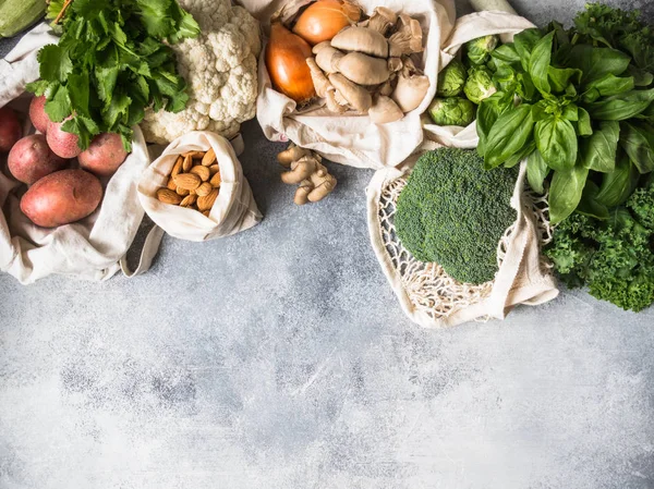 Healthy vegan ingredients for cooking. Various clean wholesome vegetables and herbs in woven bags. Products from the market without plastic. Zero waste concept flat lay. Copy space — Stock Photo, Image