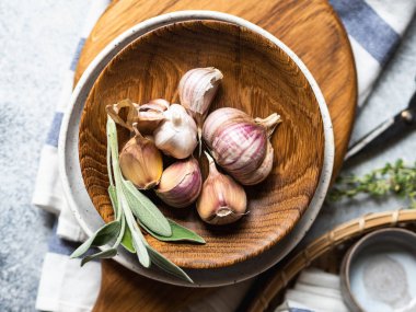 Tahta kasede sarımsak, karanfil, ampul ve otlar..