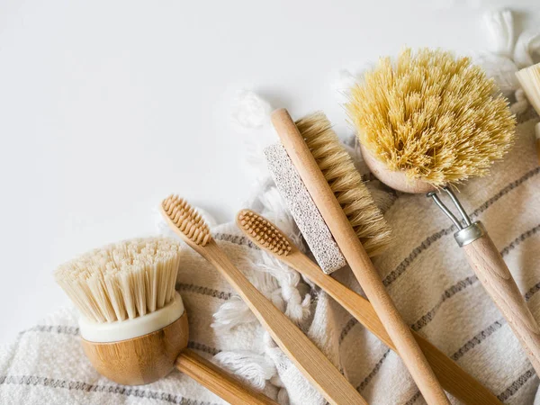 Dish washing brushes, bamboo toothbrushes, bamboo towel. Sustainable lifestyle zero waste concept. Clean without waste. No plastic objects.