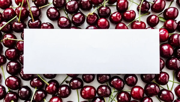 Red ripe cherry berry flat lay view on table with white empty blank mock up. Food summer concept. Top view