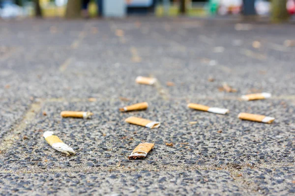 cigarette butts on the street smoking is bad for your health