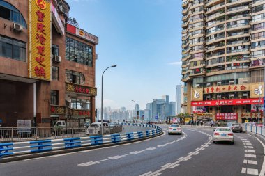 CHONGQING, CHINA - SEPTEMBER 19: View of a street in the downtown area which connects to Qiansimen bridge on September 19, 2018 in Chongqing clipart