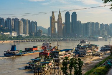 CHONGQING, CHINA - SEPTEMBER 19: Yangtze River view of city buildings and boats near the Chaotianmen docks on September 19, 2018 in Chongqing clipart