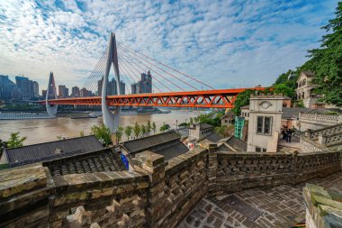 CHONGQING, CHINA - SEPTEMBER 21: This is a view of Longmenhao old street and Dongshuimen bridge along the Yangtze river on September 21, 2018 in Chongqing clipart