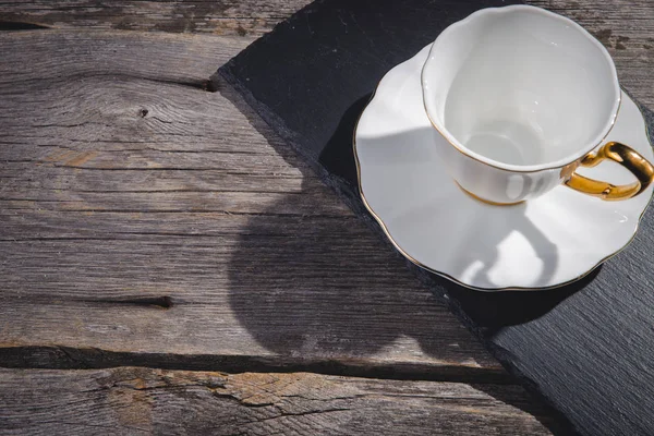 Red coffee cup on wooden table over red grunge background