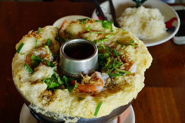 top view, Thai sea food steam eggs, steam eggs on hot pot with topping with shrimp and vegetable.