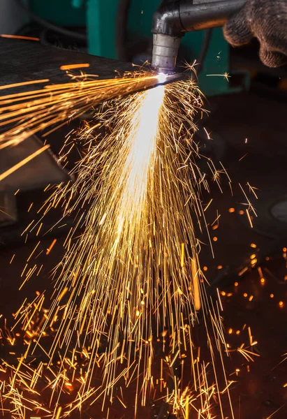 manufacturing metal construction by cutting to shape using huge orange sparks