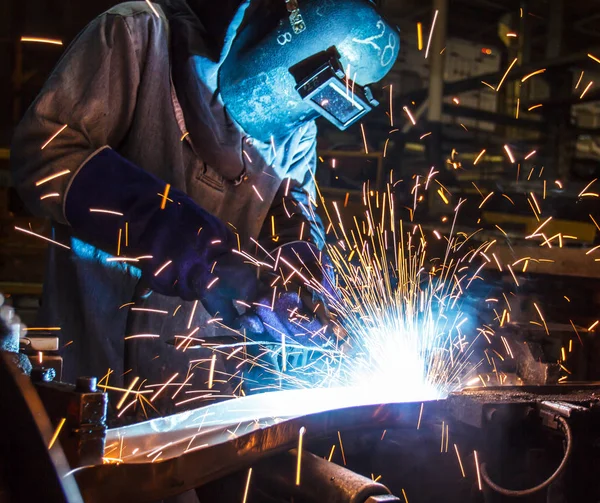 The movement of workers with protective mask welding metal.