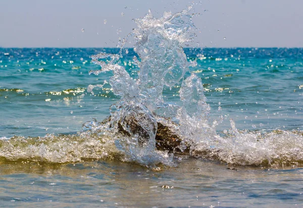 Stormy waves hitting rock on a tropical beach