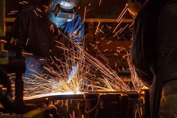 The movement of workers with protective mask welding metal.