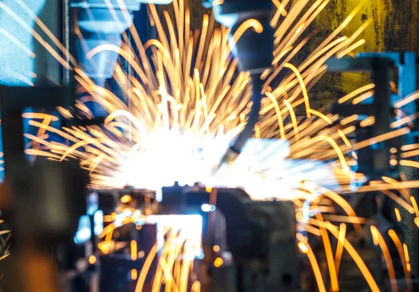 Welding robots movement in a car factory (manufacturing, industry, factory)