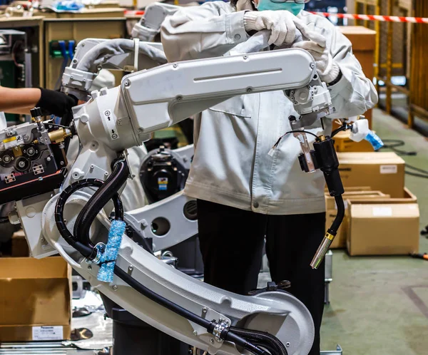 Assembly of industrial robots, People work with robots in industry.