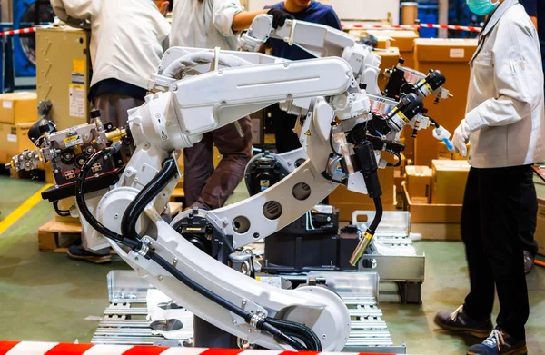 Engineers make industrial robot assembly steps to work automatically.