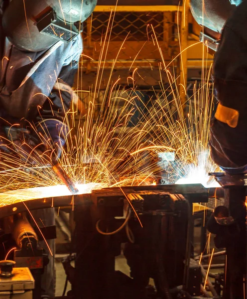 worker with protective mask welding metal