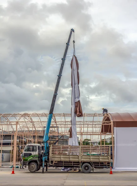 Technician install tensile fabric structure