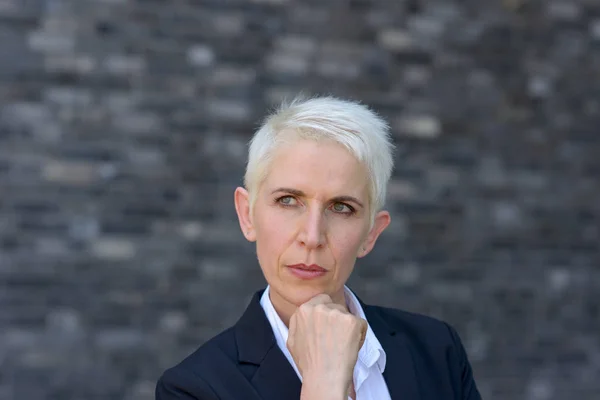 Thoughtful Woman Her Hand Her Chin Brick Wall — Stock Photo, Image