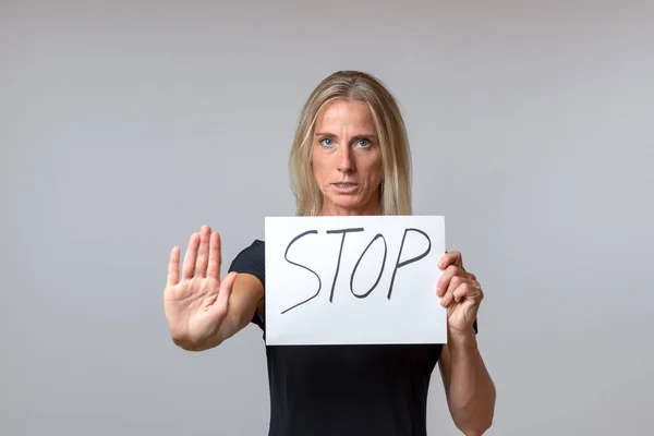 Determined Woman Holding Stop Sign Handwritten White Card While Making — Stock Photo, Image