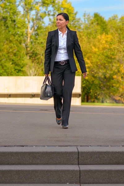 Businesswoman Wearing Black Suit Walking Grey Parking Lot Tall Green — Stock Photo, Image