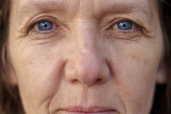 Visage recadré d'une femme d'âge moyen aux yeux bleus — Photo