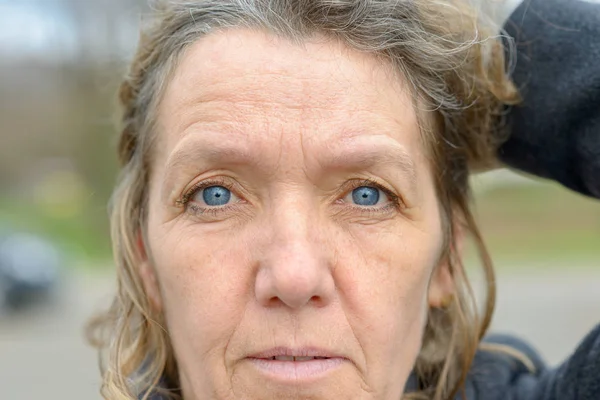 Face of middle aged woman with blue eyes — Stock Photo, Image