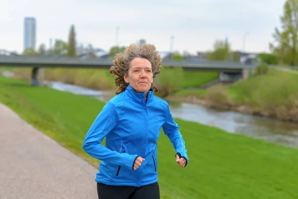 Fit athletic middle-aged woman jogging