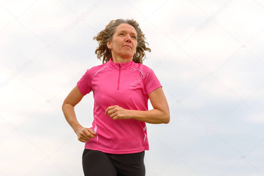 Woman jogging, viewed from low angle