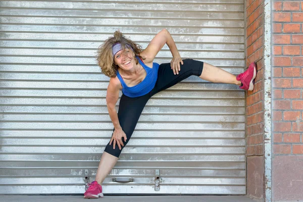 Happy laughing fit middle-aged woman