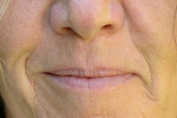 Close up on the mouth and lips of a smiling woman — Stock Photo, Image