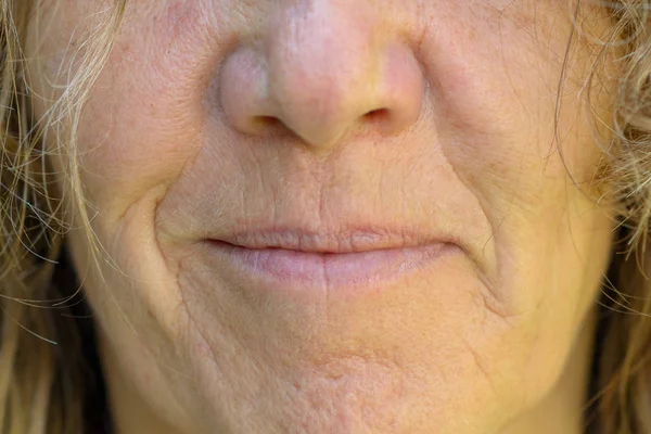 Close up on the mouth and lips of a smiling woman — Stock Photo, Image
