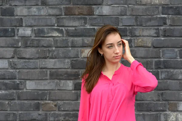 Attractive trendy woman wearing colorful pink top