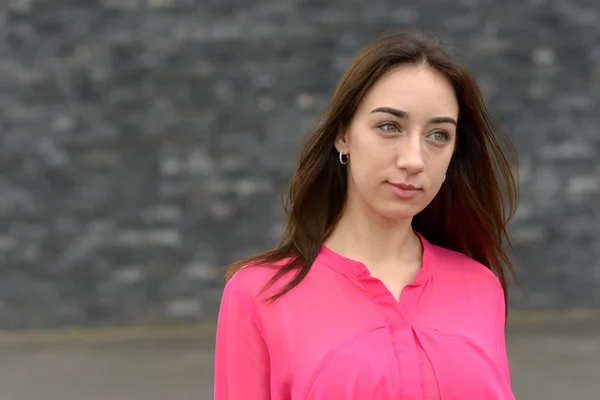 Serious thoughtful young woman standing watching — Stock Photo, Image