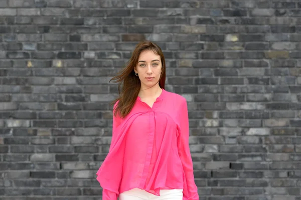 Attractive trendy woman wearing colorful pink top