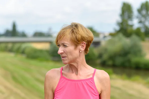 Serious woman looking aside watching — Stock Photo, Image