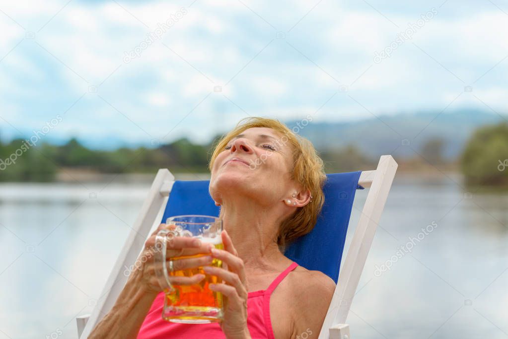 Woman savoring a pint of cold beer