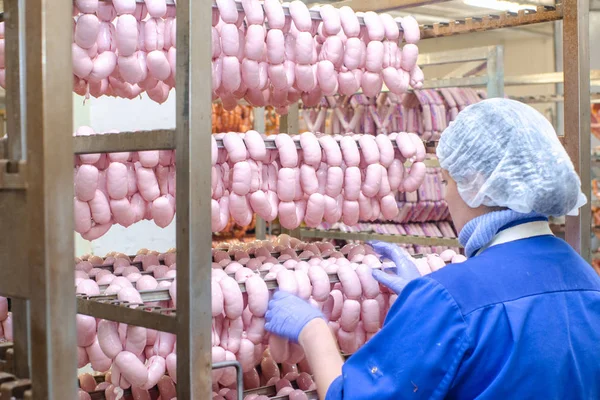 Sausage. Sausage production line. Process of sausage manufacturing. Industrial manufacturing of sausages. Meat shop.