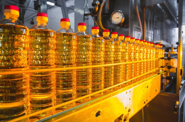 Sunflower oil. Factory line of production and filling of refined oil from sunflower seeds. Factory conveyor of food industry.