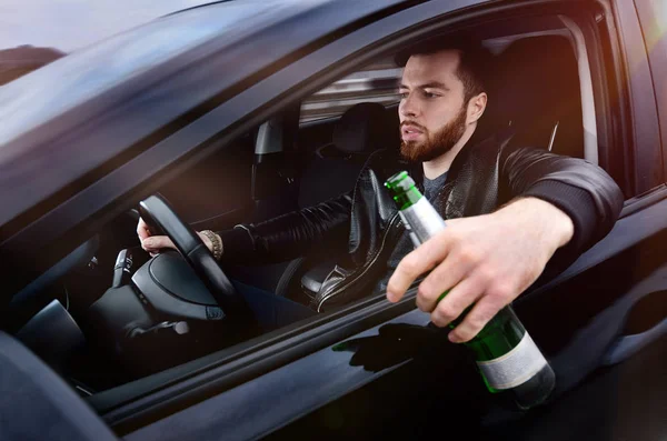 Drinks alcohol in the car. The guy with beer at the wheel. Man with beer. emergency situation. Social