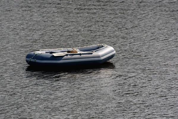 Empty inflatable boat floats on the water. Boat without a master, the loss.