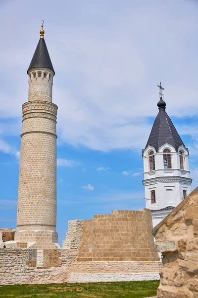 The minaret of the mosque and the Orthodox Church in the Bulgar historical and archaeological monument near Kazan.