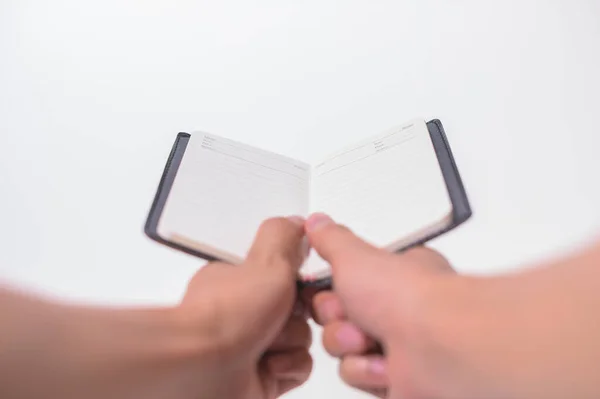 Holding a notebook on a white background